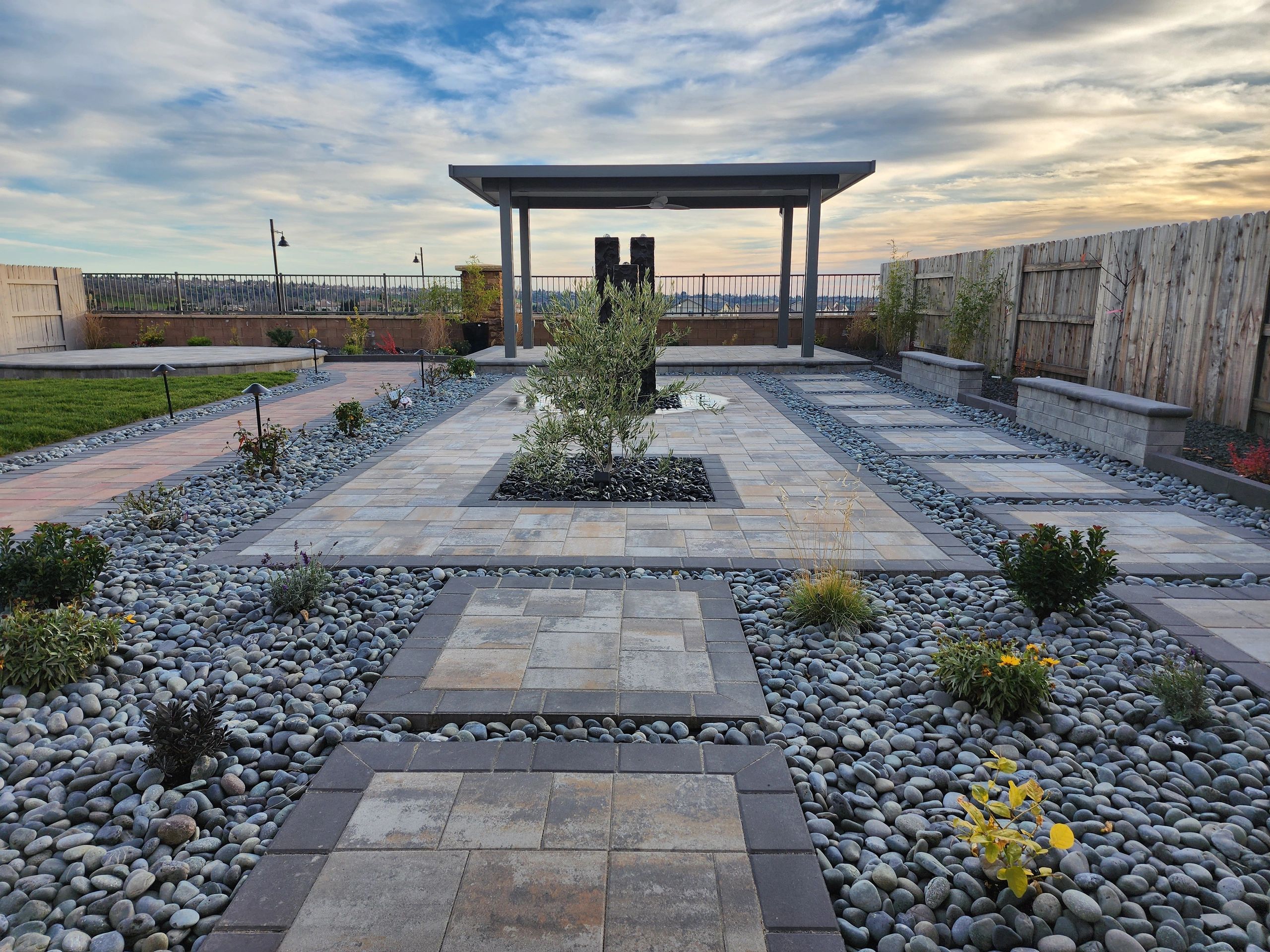 Pergola, pavers, planting, and water feature design